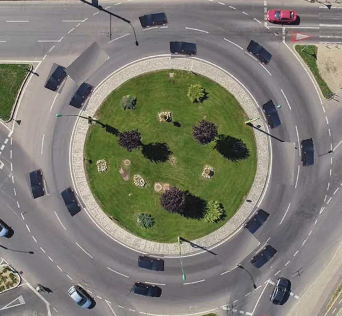 A two lane roundabout with cars 3 car lengths away from each other